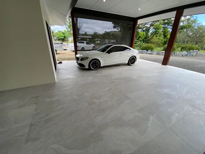 Undercover carport tiled in large-format grey stone-look tiles