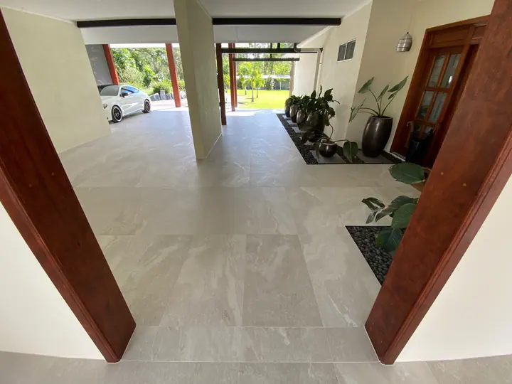 Covered entry with large-format stone-look floor tiles
